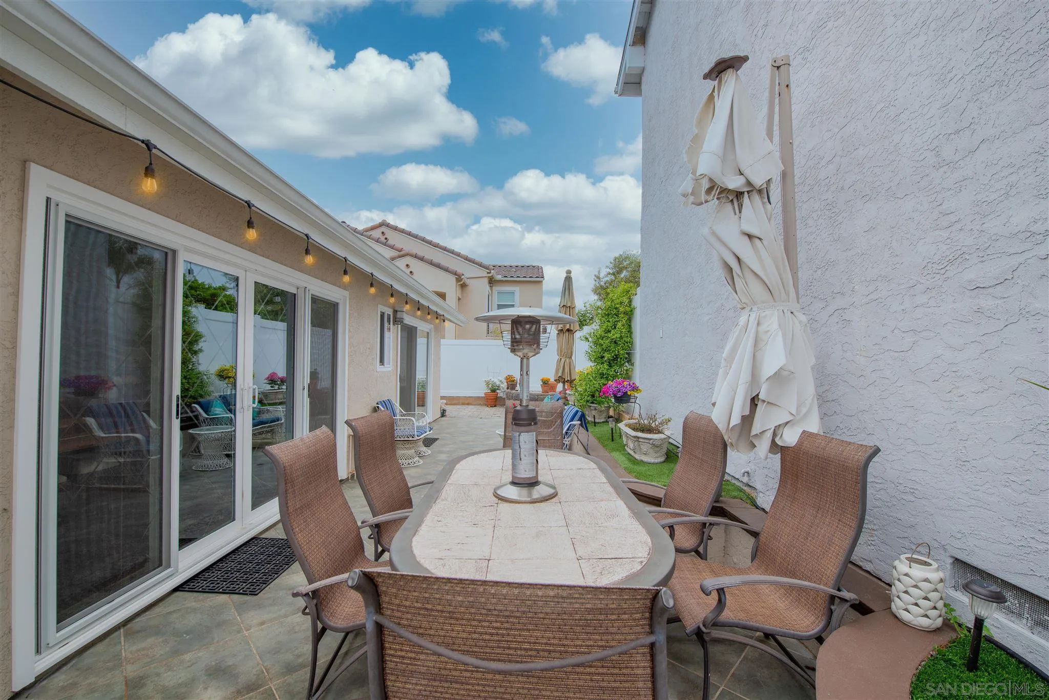 710 Anchor Way Carlsbad, CA 92008 - Photo 28 of 33 a view of a patio with table and chairs and potted plants