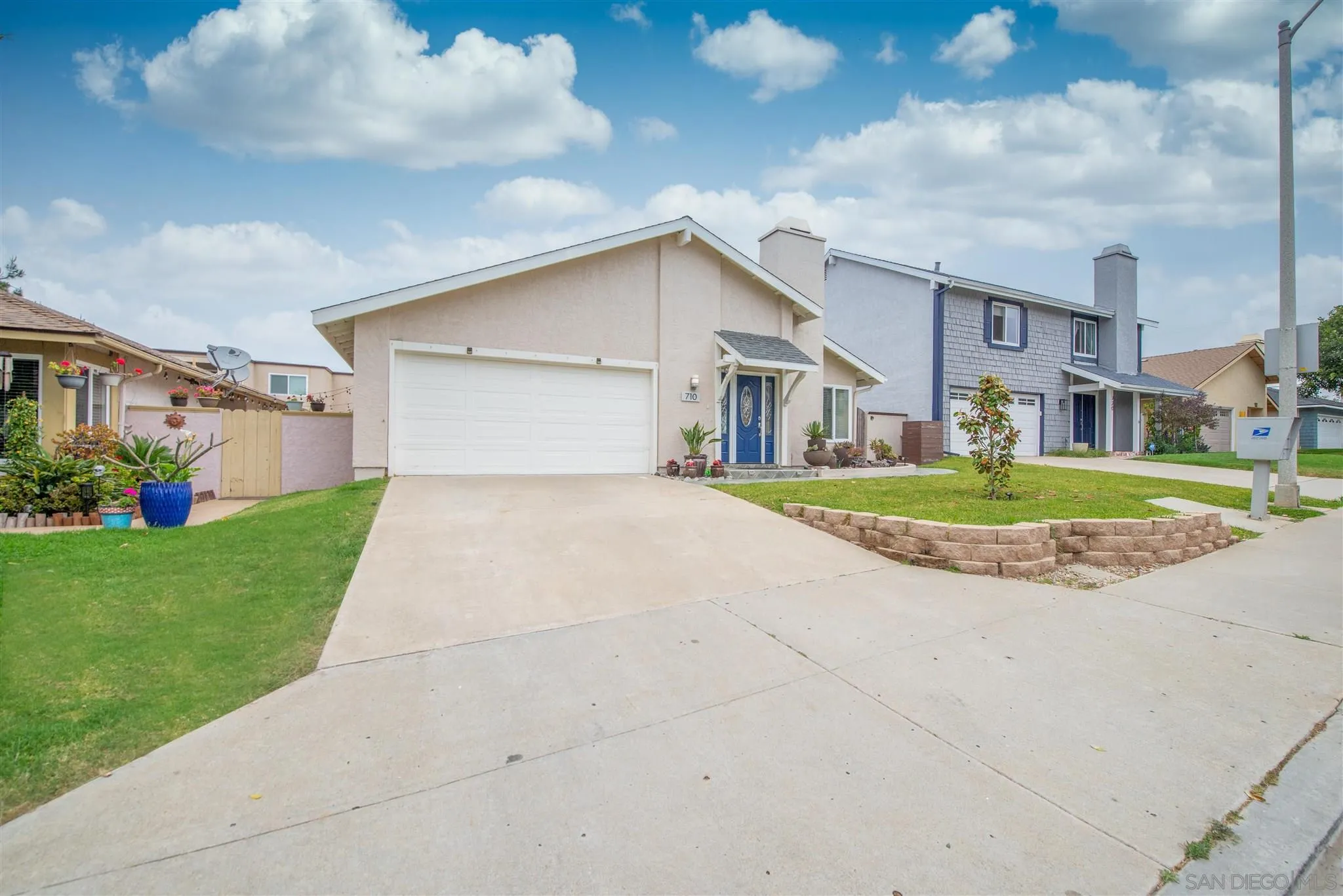 710 Anchor Way Carlsbad, CA 92008 - Photo 3 of 33 a front view of a house with a yard and garage