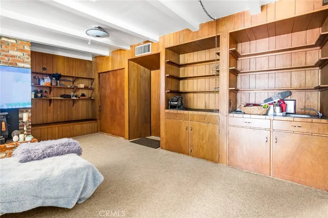 a spacious bedroom with a bed and a lamp