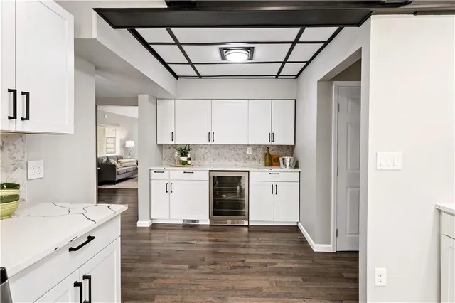 a kitchen with a refrigerator sink and cabinets