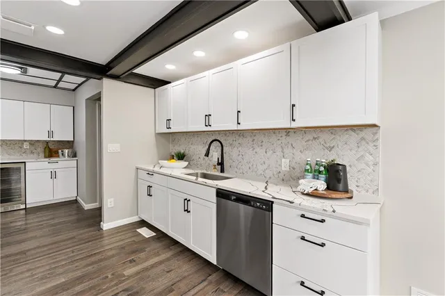 a kitchen with white cabinets and white appliances