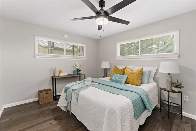 a bed sitting in a bedroom next to a window