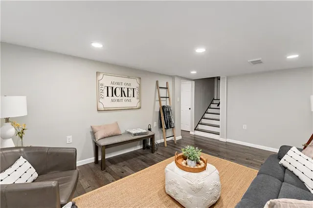 a living room with furniture and a chair