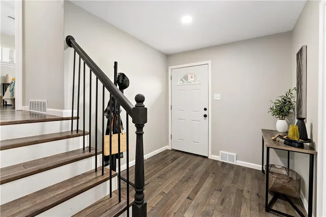 a view of entryway with wooden floor and stairs