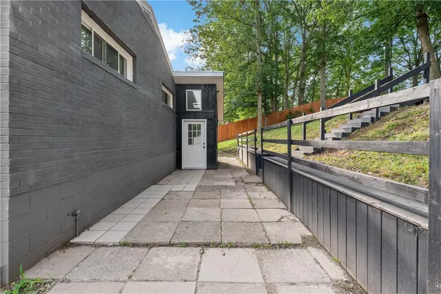 a view of balcony with wooden floor and fence