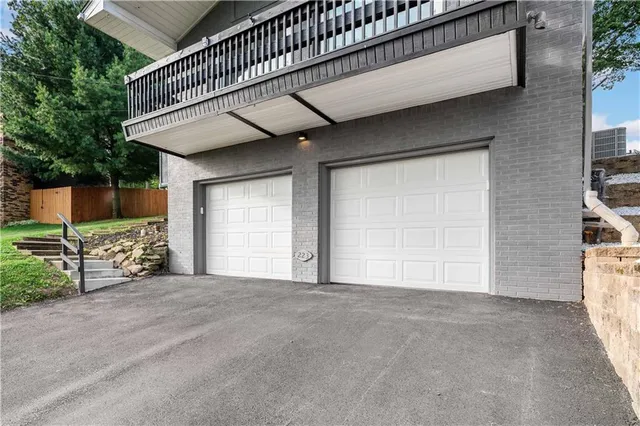 a view of an empty room with wooden fence and windows