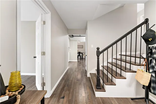 a view of entryway and hall with wooden floor
