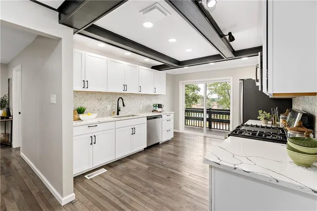 a kitchen with sink stove and cabinets