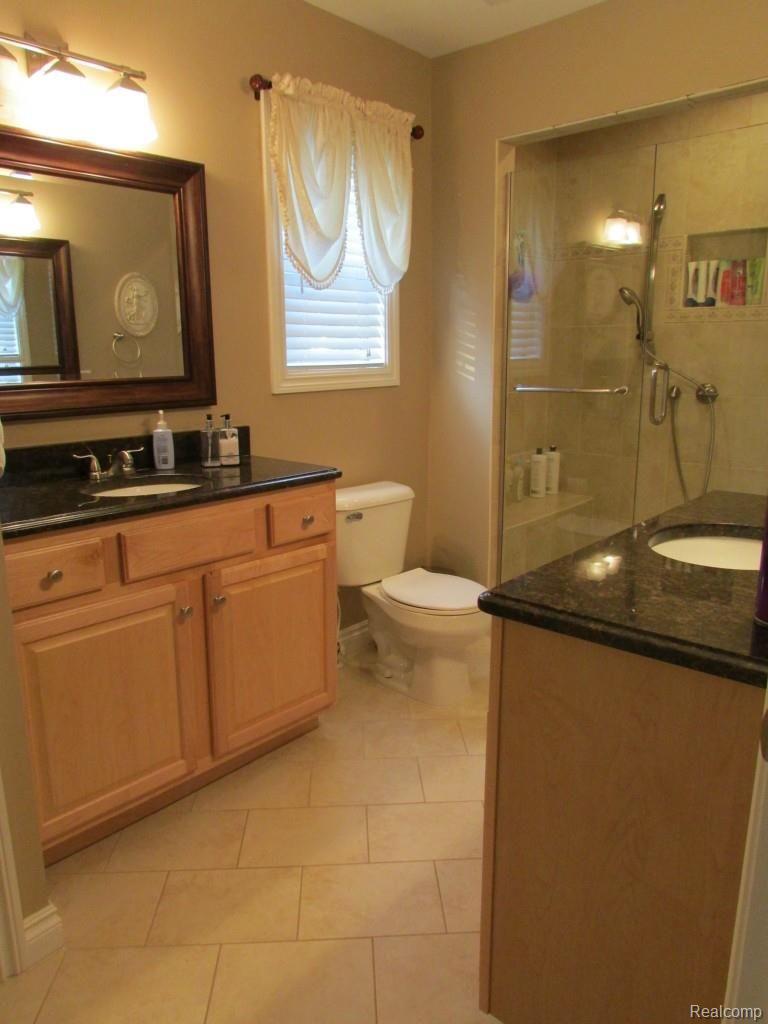 3052 St Clair Drive Rochester, MI 48309 - Photo 21 of 34 Master Bath with Double Sinks, Ceramic Shower and Floors, and Euro Shower Enclosure