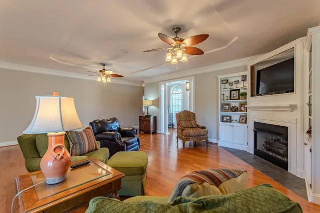 a living room with furniture fireplace and flat screen tv