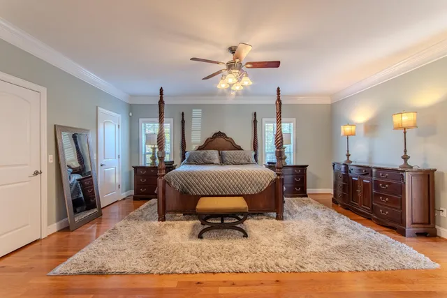 a bedroom with a bed and a chandelier