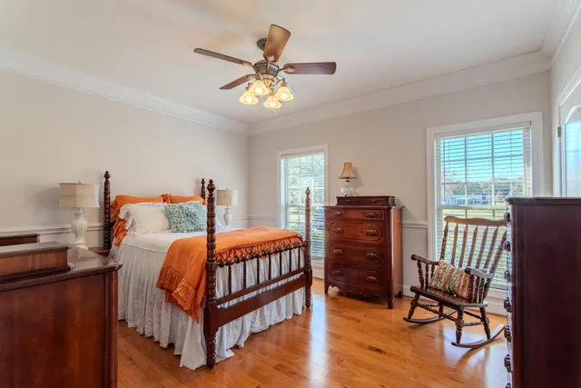 a bedroom with furniture and wooden floor