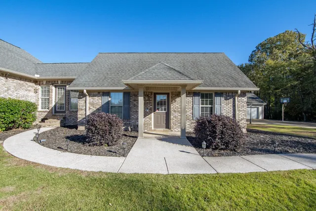 a front view of a house with garden