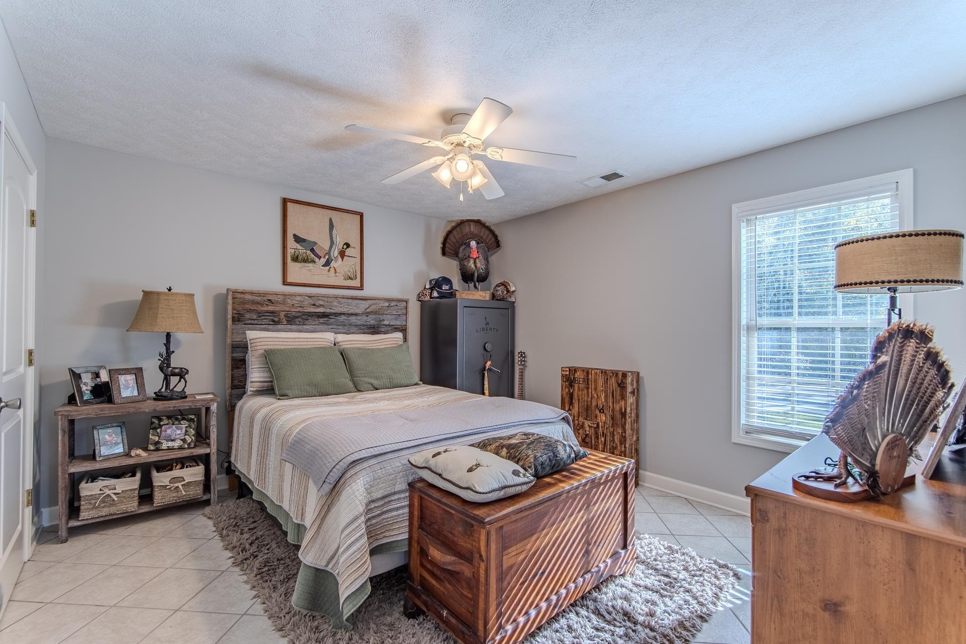 6170 Highway 226 Savannah, TN 38372 - Photo 25 of 40 a bedroom with a bed and a chandelier