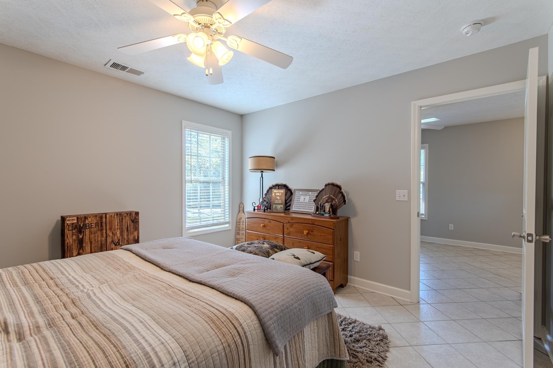6170 Highway 226 Savannah, TN 38372 - Photo 26 of 40 a bedroom with a bed and a chandelier