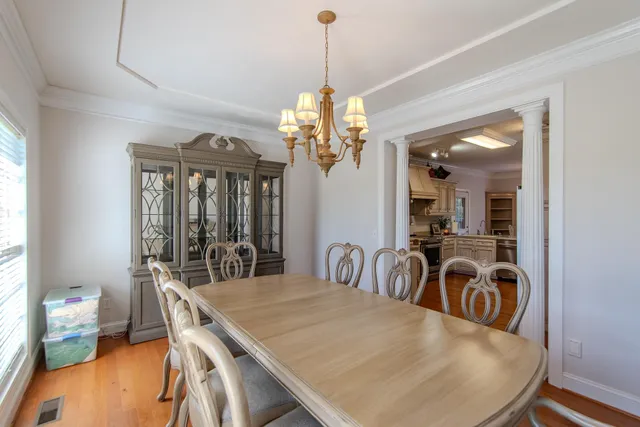 a view of a dining room with furniture and chandelier