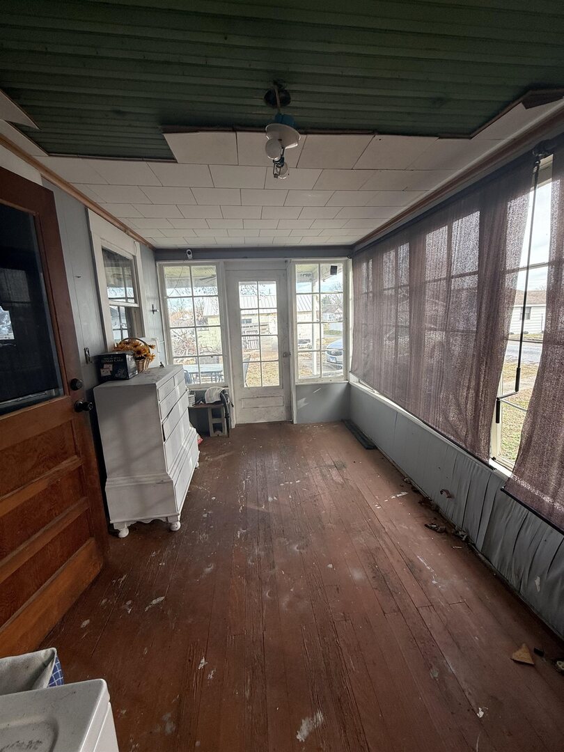 404 South Thomas Street Christopher, IL 62822 - Photo 12 of 16 a view of an empty room with wooden floor and a window