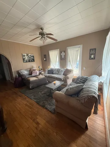 a living room with furniture and a chandelier