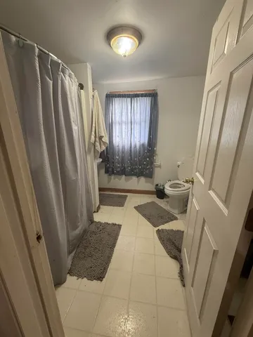 a bathroom with sink shower and a toilet