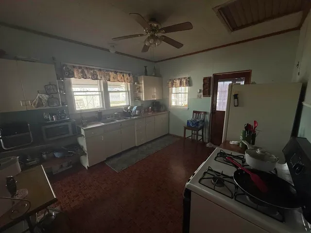 a kitchen with sink refrigerator and window