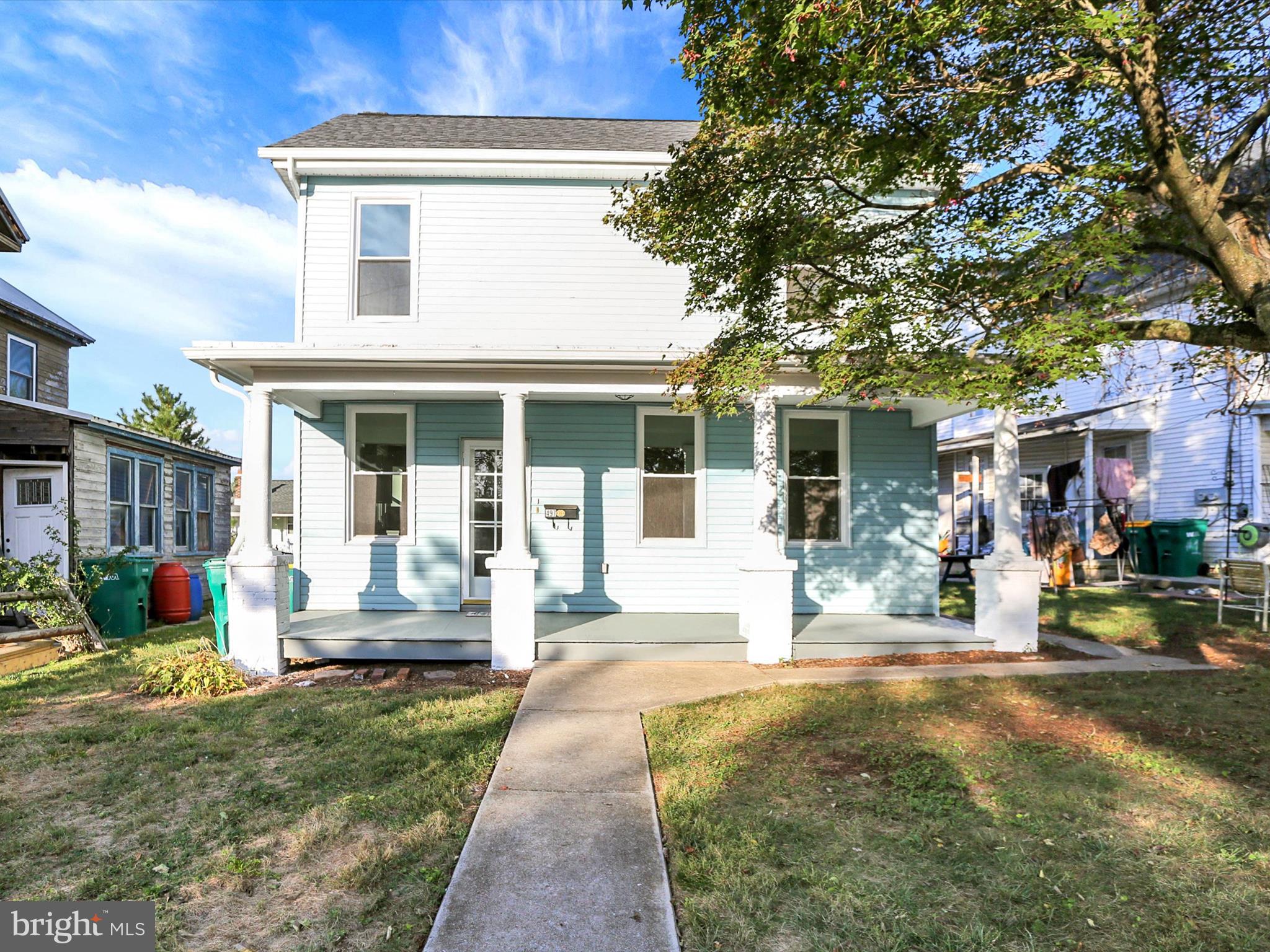 497 State Street Enola, PA 17025 - Photo 2 of 47 a front view of a house with a garden and porch