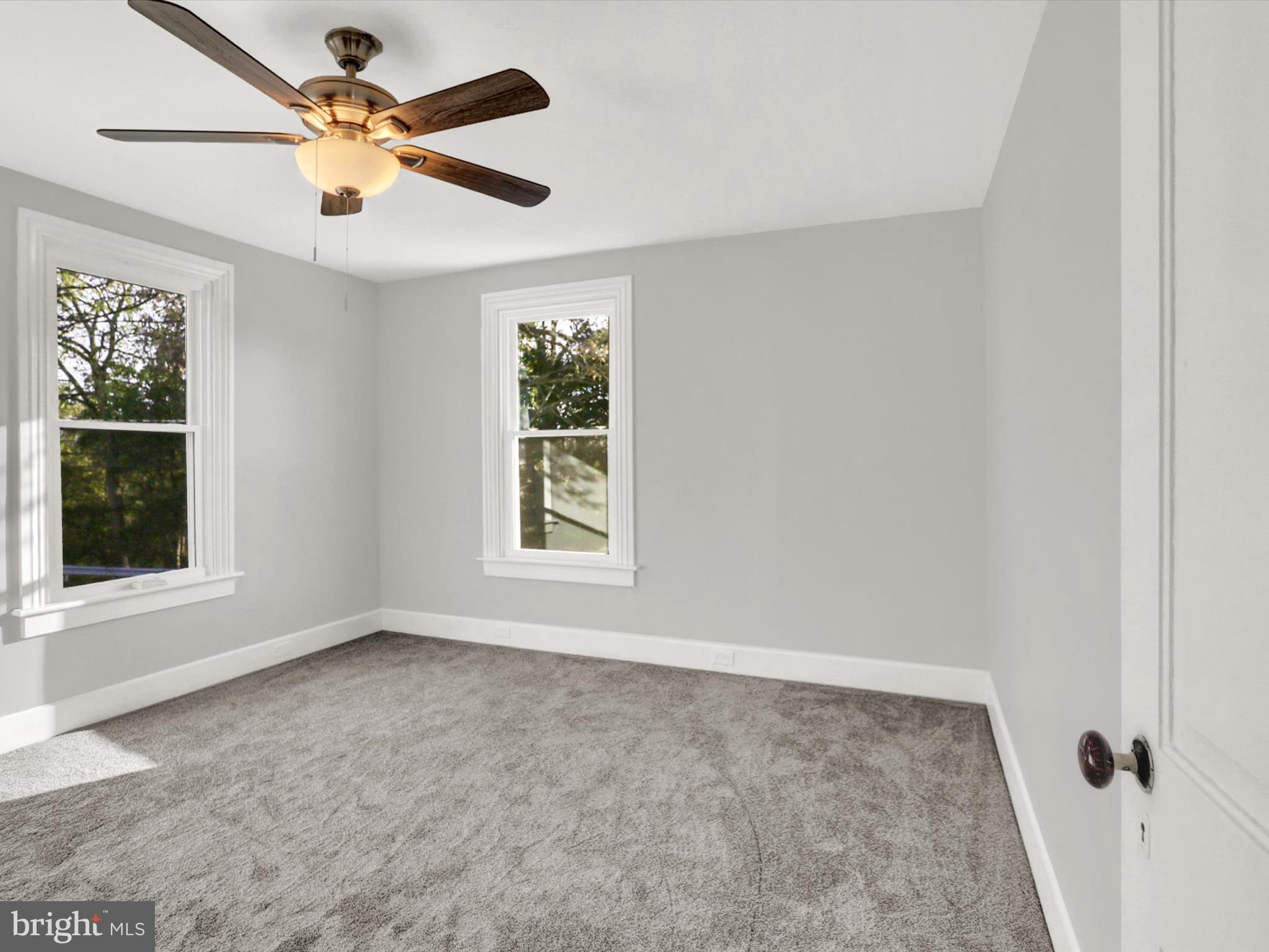 497 State Street Enola, PA 17025 - Photo 25 of 47 an empty room with windows and fan