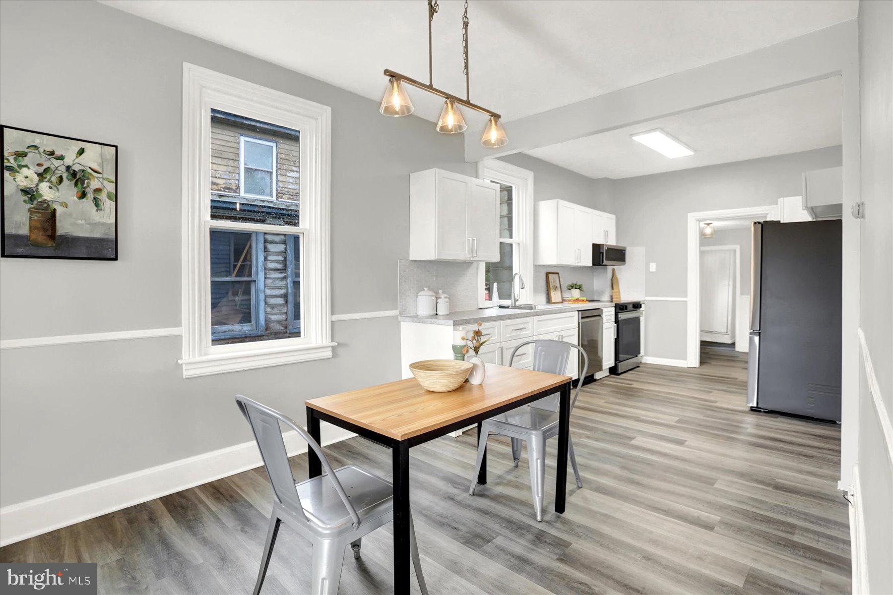 497 State Street Enola, PA 17025 - Photo 4 of 47 a kitchen with a table chairs refrigerator and microwave