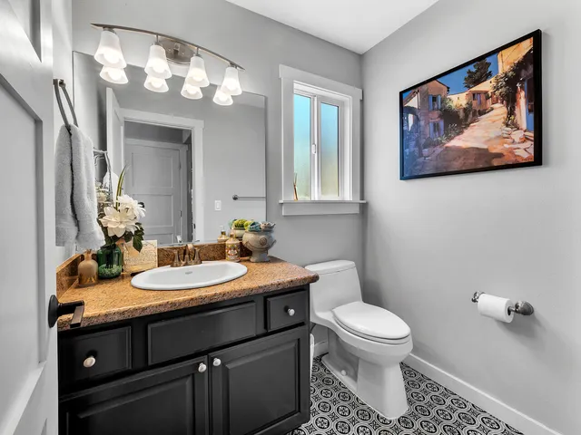 a bathroom with a toilet a sink and mirror