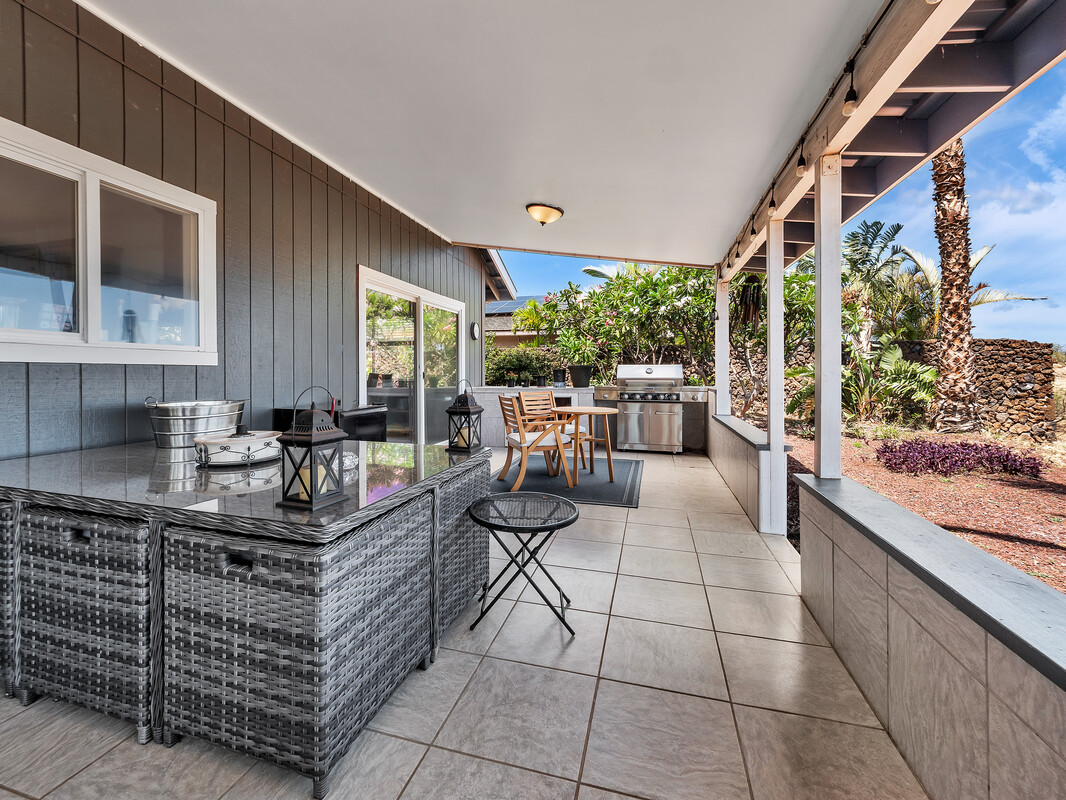 68-3679 Kokee Street Waikoloa, HI 96738 - Photo 20 of 28 a kitchen with stainless steel appliances granite countertop a stove a sink and a microwave