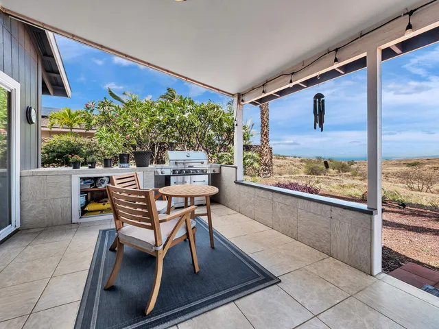 a dining room with furniture and a floor to ceiling window