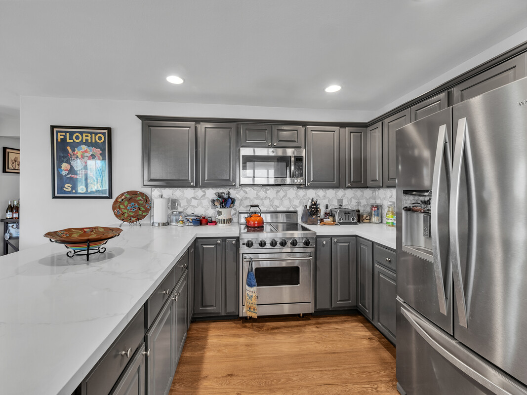 68-3679 Kokee Street Waikoloa, HI 96738 - Photo 8 of 28 a kitchen with stainless steel appliances granite countertop a refrigerator sink and stove