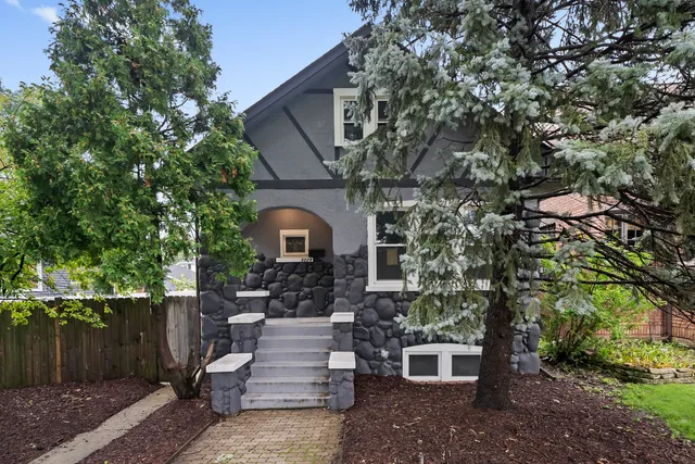 a front view of a house with plants