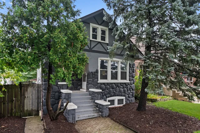 a front view of a house with outdoor seating