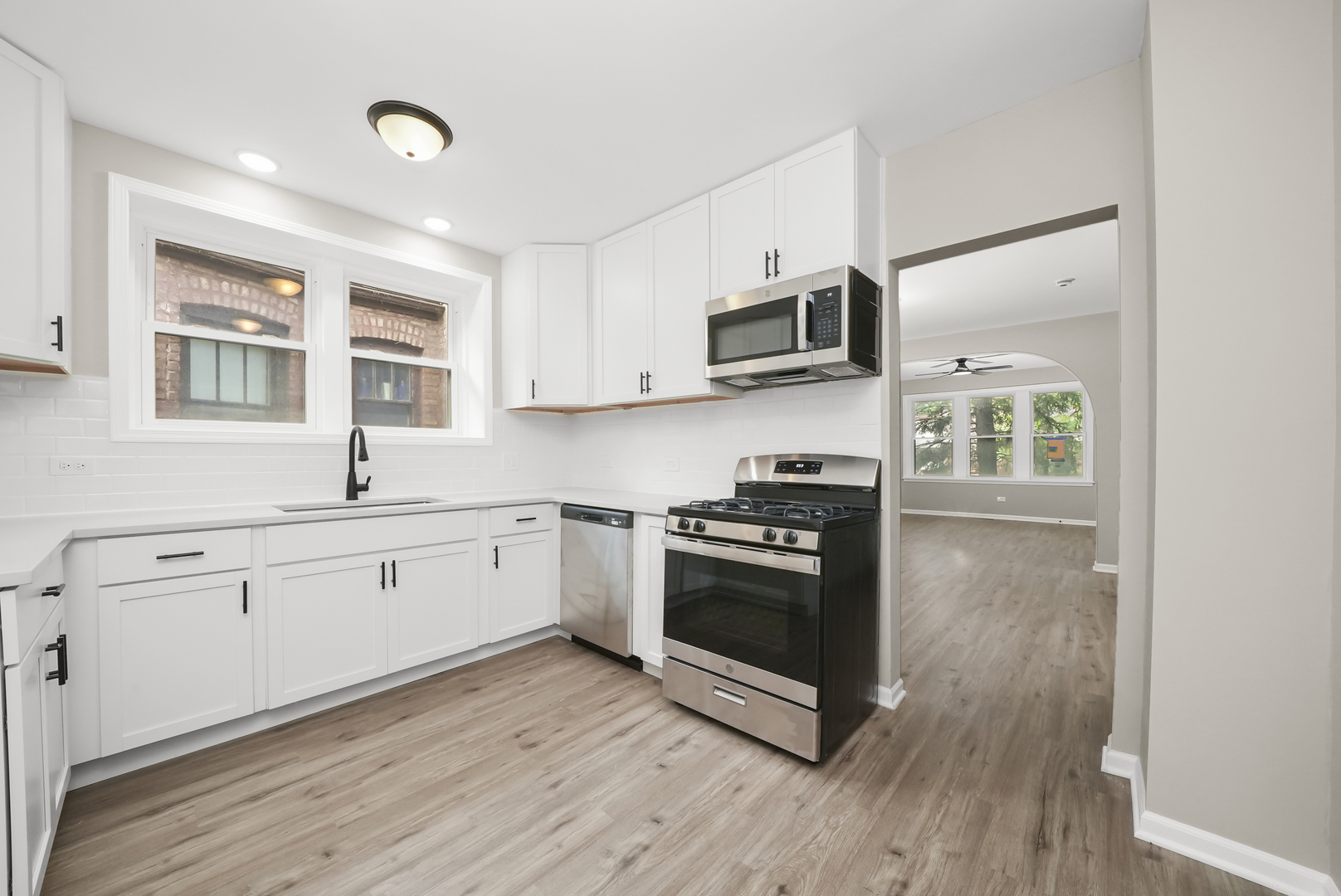3229 Maple Avenue Brookfield, IL 60513 - Photo 4 of 14 a kitchen with stainless steel appliances granite countertop a stove a sink and a microwave