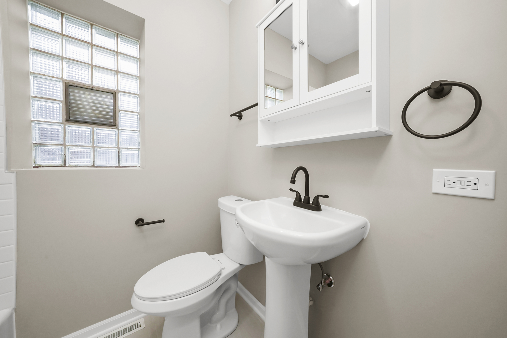 3229 Maple Avenue Brookfield, IL 60513 - Photo 9 of 14 a bathroom with a sink a mirror and a toilet