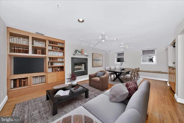 a living room with furniture flat screen tv and fireplace