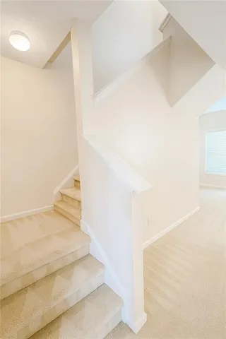 a view of staircase with white walls