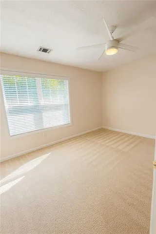 an empty room with a empty space and windows