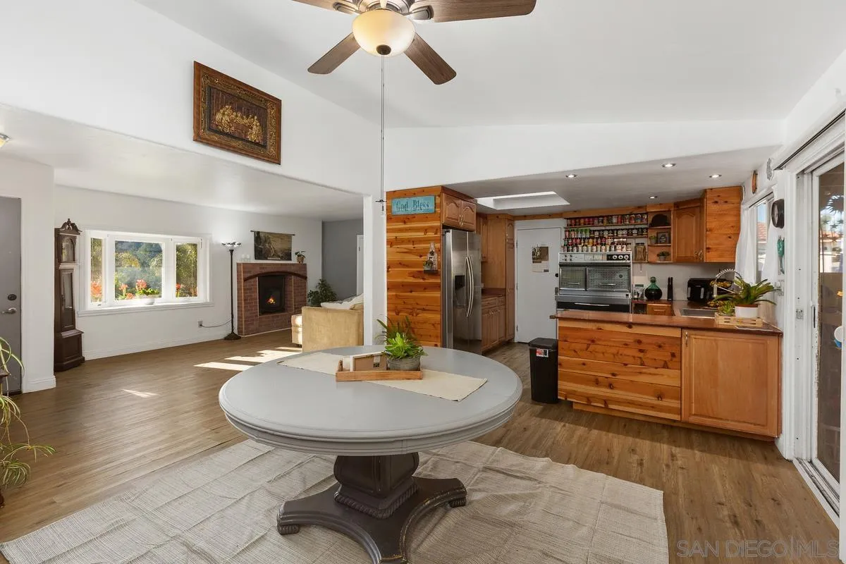 14164 Lyons Valley Road Jamul, CA 91935 - Photo 11 of 33 a kitchen with stainless steel appliances kitchen island granite countertop a sink cabinets and wooden floor