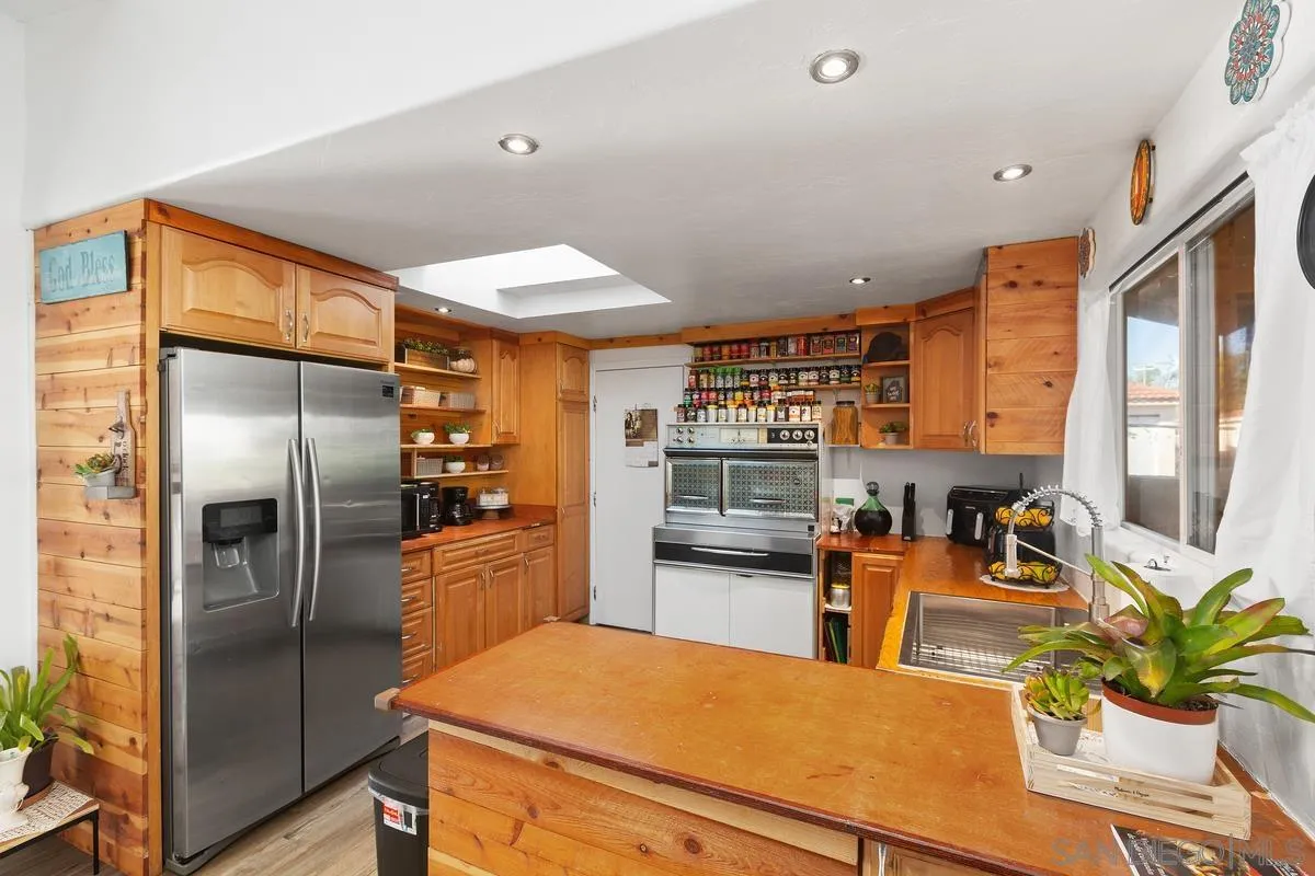 14164 Lyons Valley Road Jamul, CA 91935 - Photo 13 of 33 a kitchen with stainless steel appliances a refrigerator and a counter space