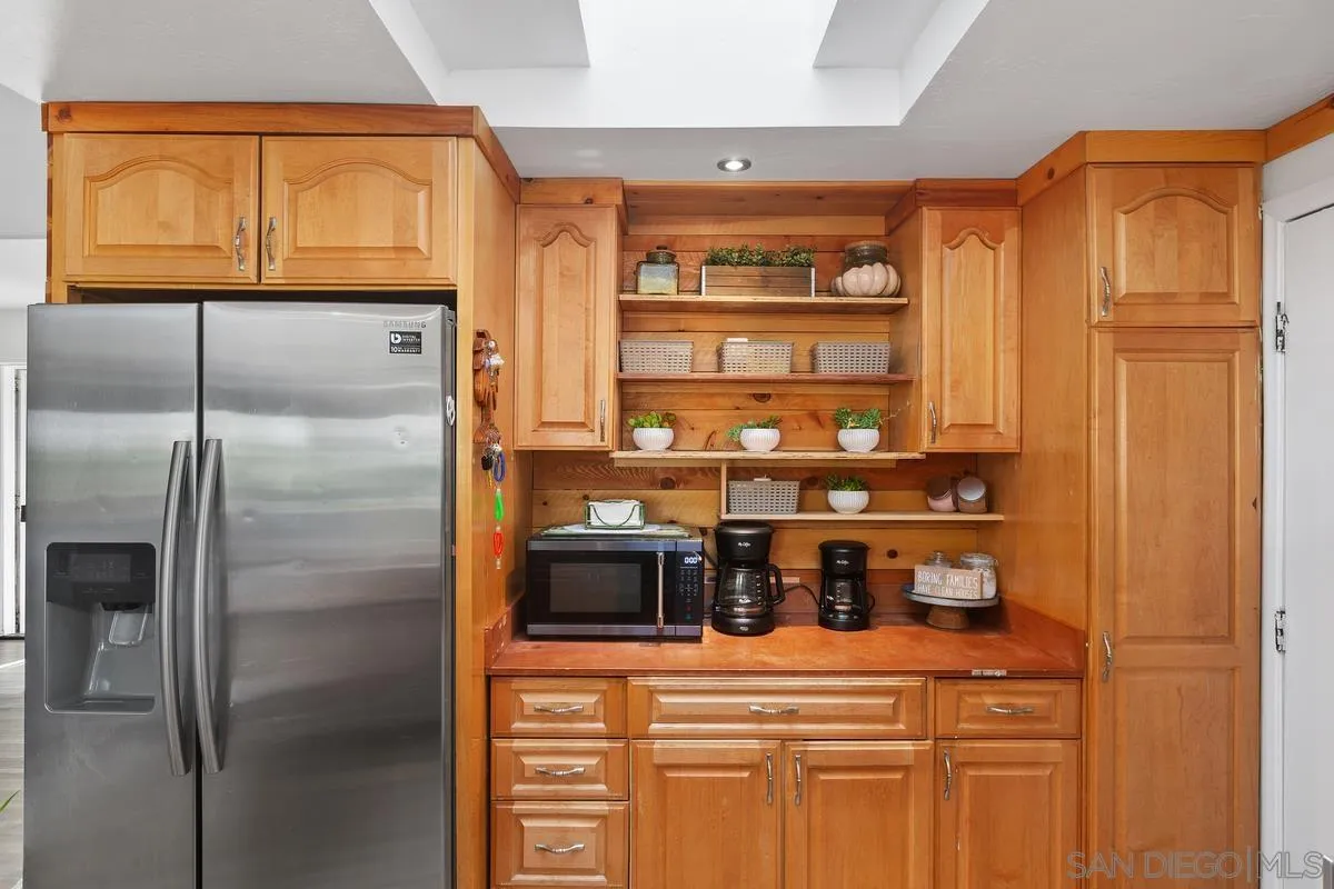 14164 Lyons Valley Road Jamul, CA 91935 - Photo 14 of 33 a kitchen with stainless steel appliances a refrigerator and cabinets