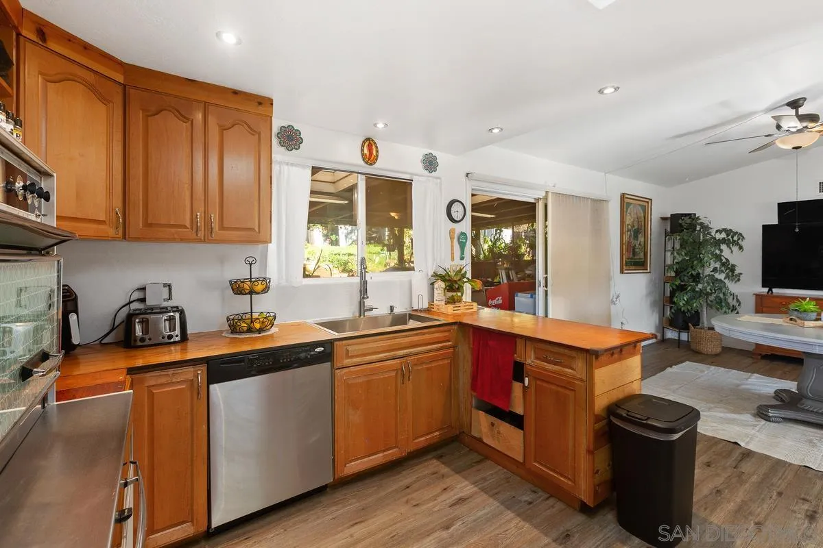 14164 Lyons Valley Road Jamul, CA 91935 - Photo 15 of 33 a kitchen with stainless steel appliances granite countertop a sink a stove and a wooden floors