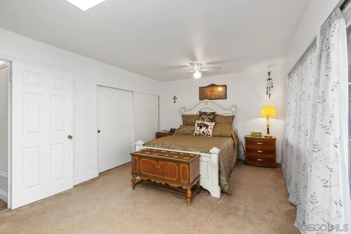 14164 Lyons Valley Road Jamul, CA 91935 - Photo 17 of 33 a bedroom with a bed and a lamp on the dresser