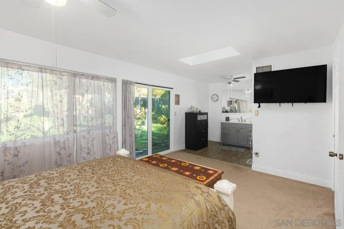 14164 Lyons Valley Road Jamul, CA 91935 - Photo 18 of 33 a bedroom with a bed and a flat screen tv