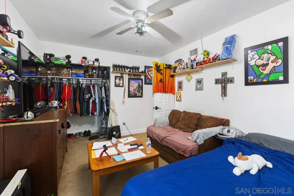 14164 Lyons Valley Road Jamul, CA 91935 - Photo 22 of 33 a living room with furniture kitchen view and a flat screen tv