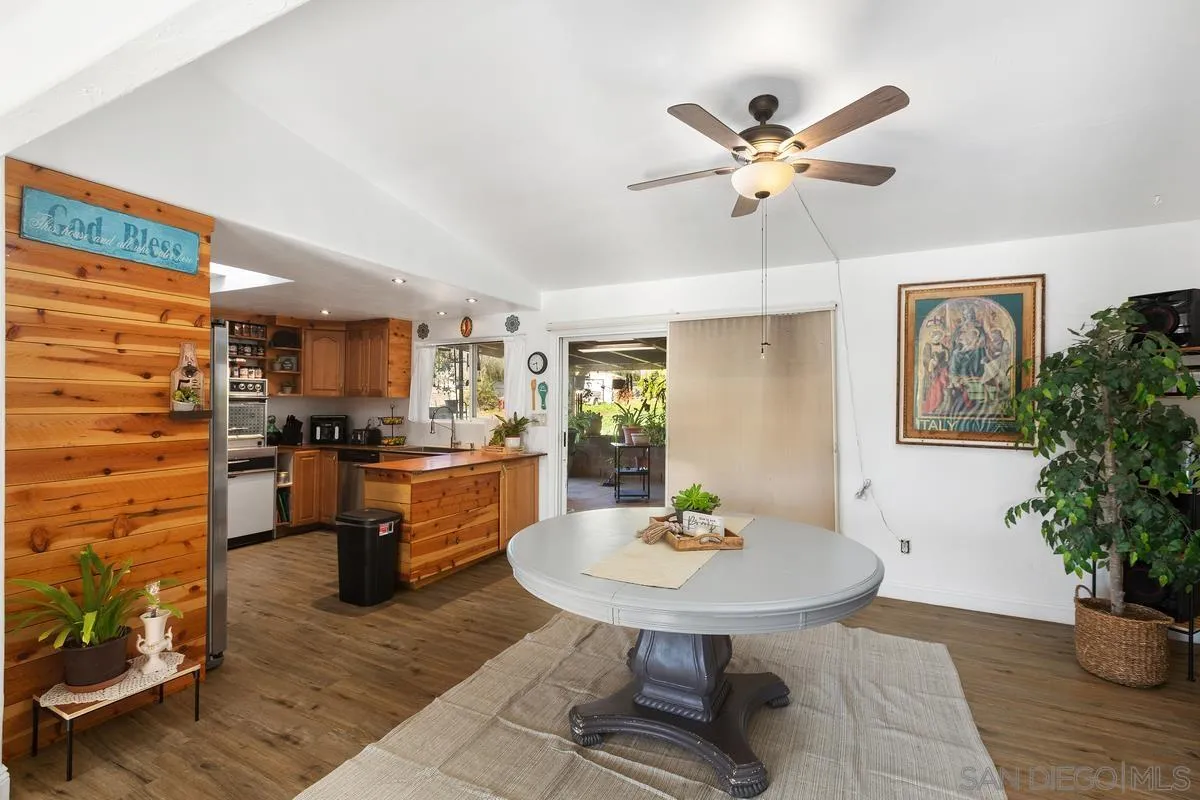 14164 Lyons Valley Road Jamul, CA 91935 - Photo 10 of 33 a dining room with kitchen view and wooden floor