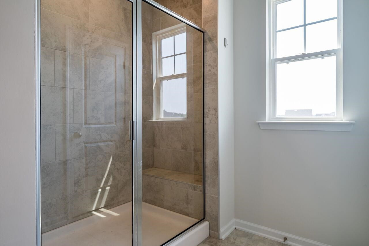 5220 Beckom Street Raleigh, NC 27616 - Photo 20 of 30 The beautiful tile shower adds charm and character. Master Suite