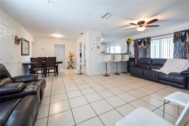 a living room with furniture and kitchen view