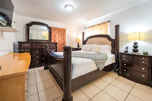 a bed room with a bed and a television