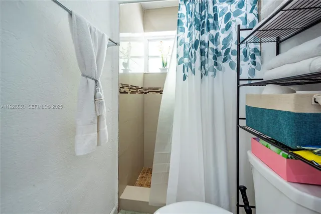 a bathroom with a toilet and shower